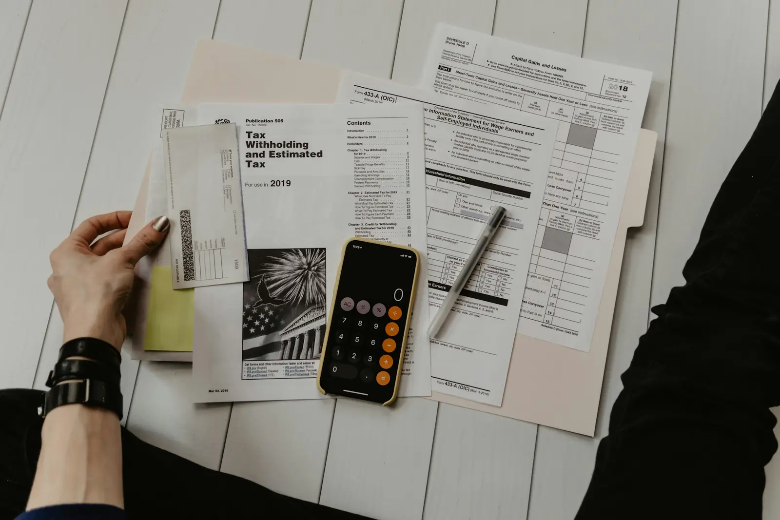 Paperwork, a phone and a calculator on a desk
