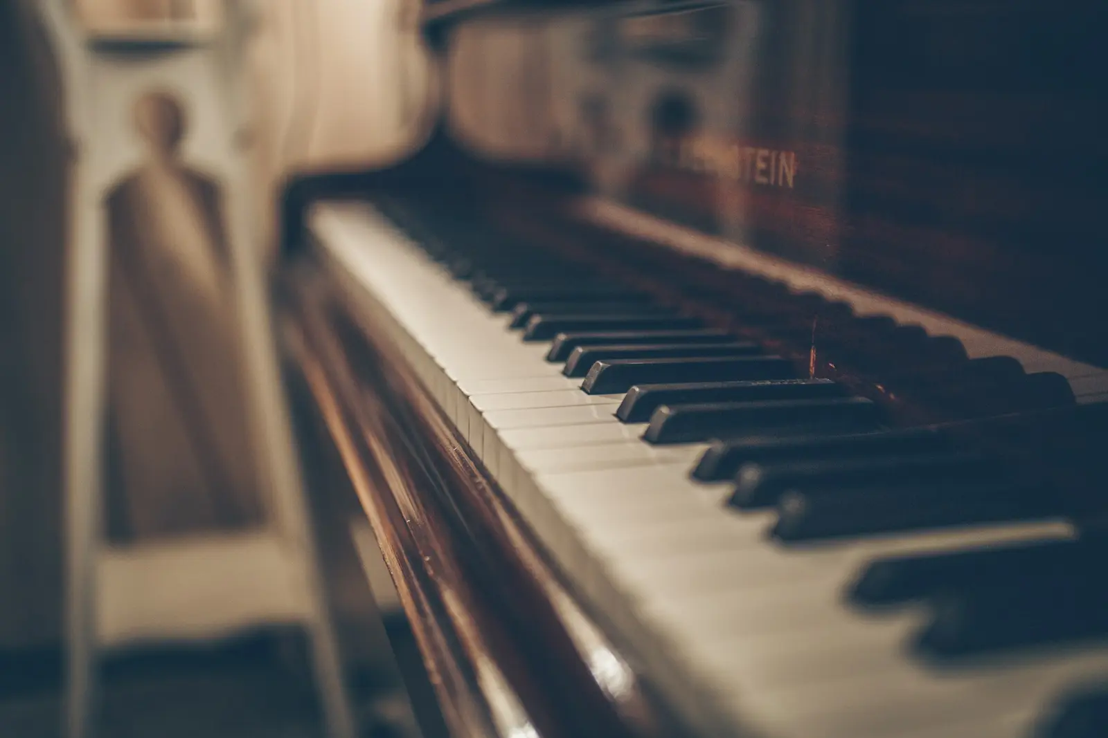 A grand piano keyboard in warm light